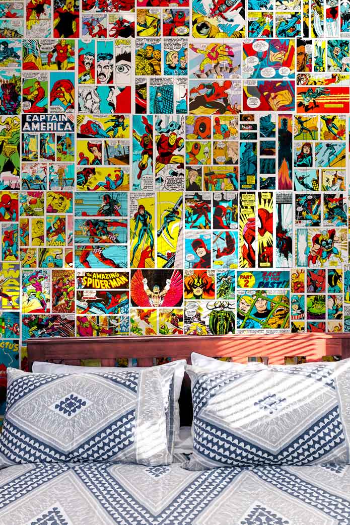 Marvel & DC comics posters collage kit behind a bed