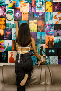 Girl climbing on couch with posters behind