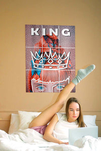 girl raising her leg up on the bed with block kit posters on the wall