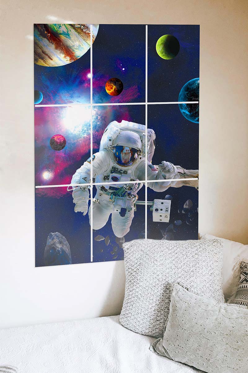 block kit astronaut poster on the wall behind bed